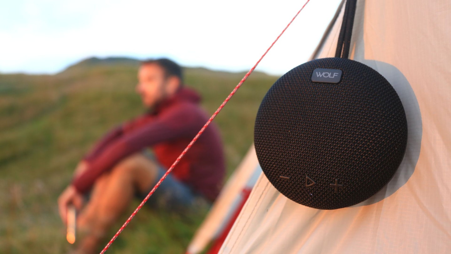 Hiker testing the Wolf C200 Waterproof Speaker on a wild camp