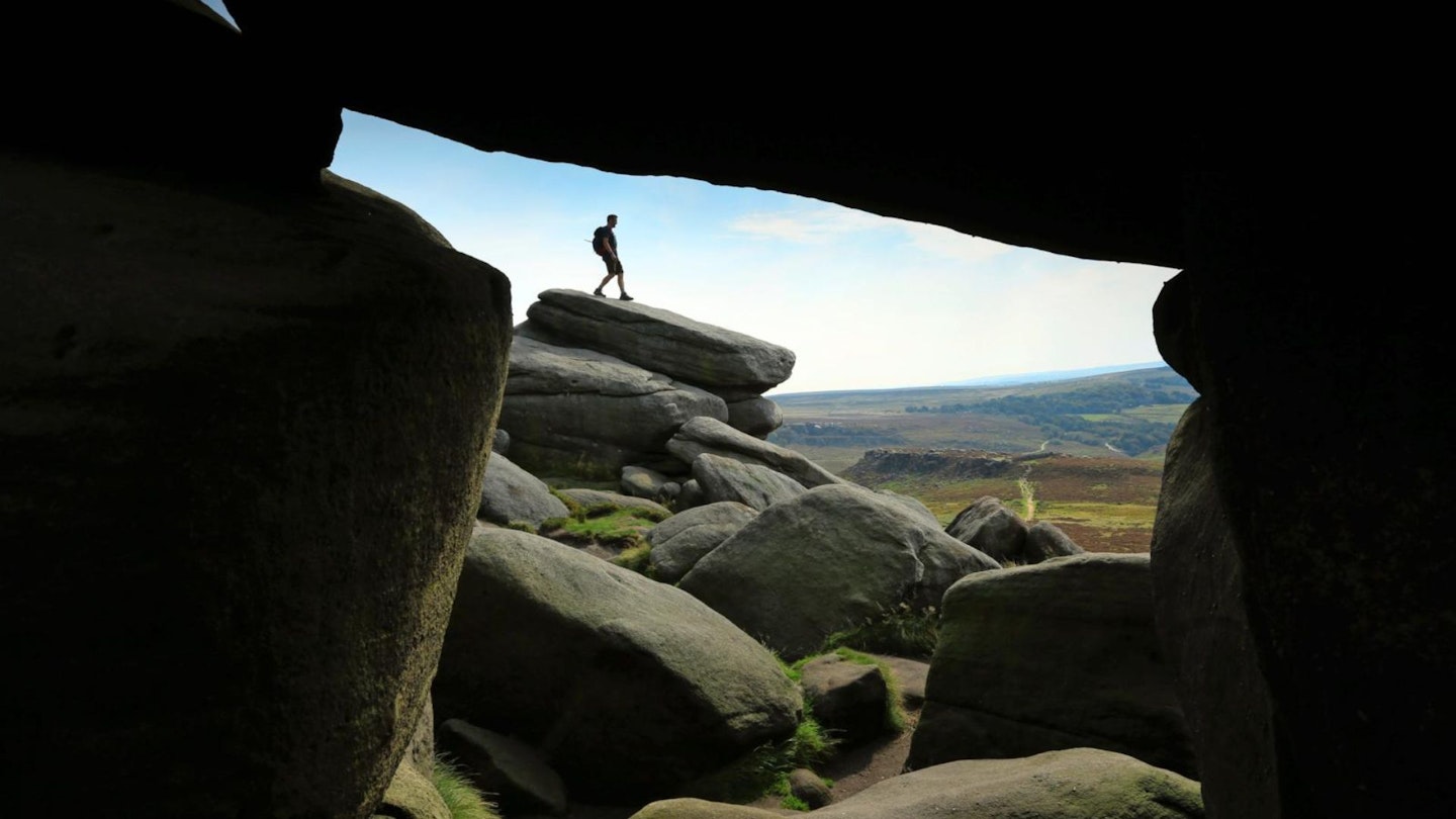 Padley Gorge and Higger Tor man silhouetted on the rocks