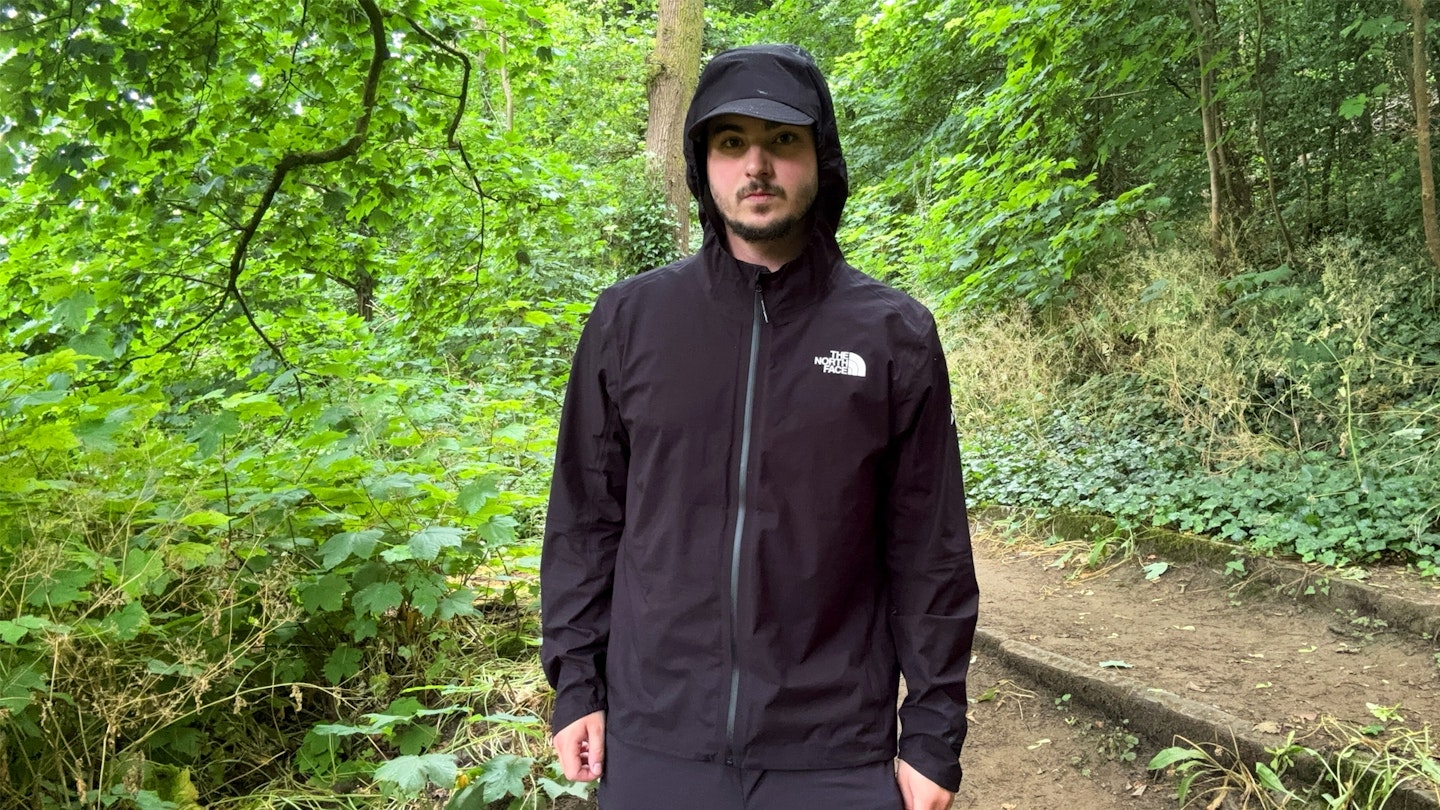 The North Face Summit Superior Futurelight waterproof running jacket being tested in the woods