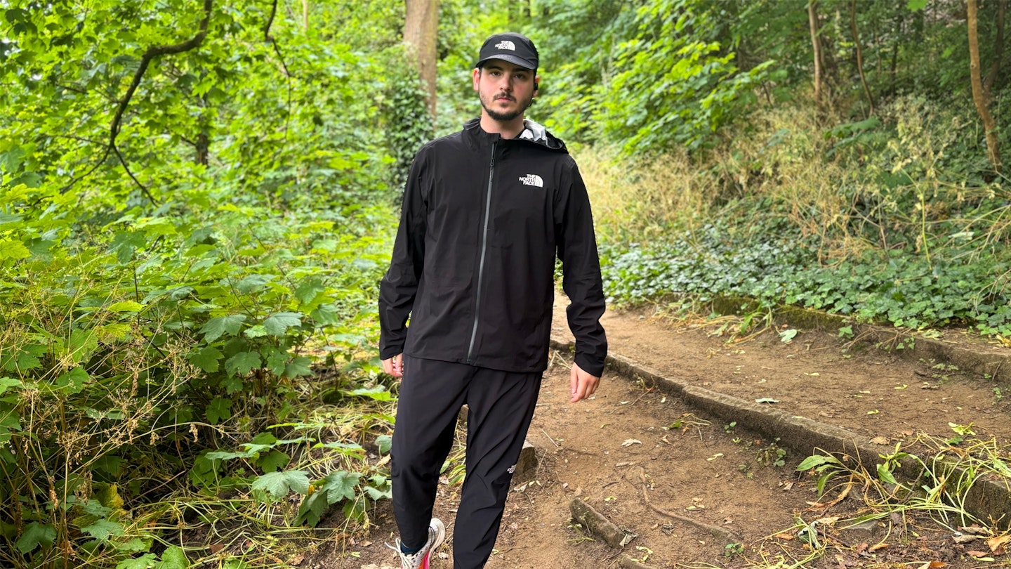 The North Face Summit Superior Futurelight waterproof running jacket being tested in the woods