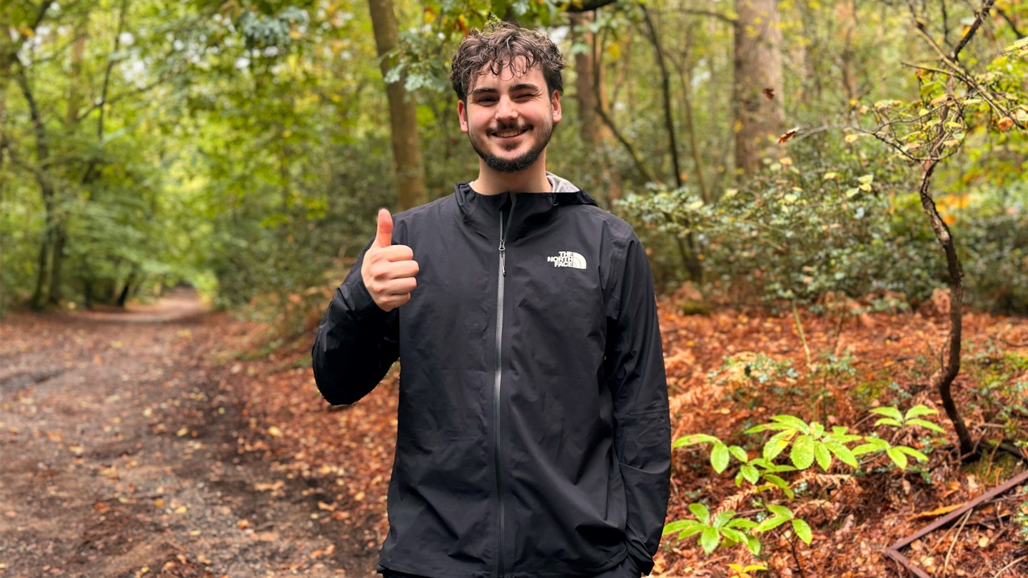 The North Face Summit Superior Futurelight waterproof running jacket being tested in the woods