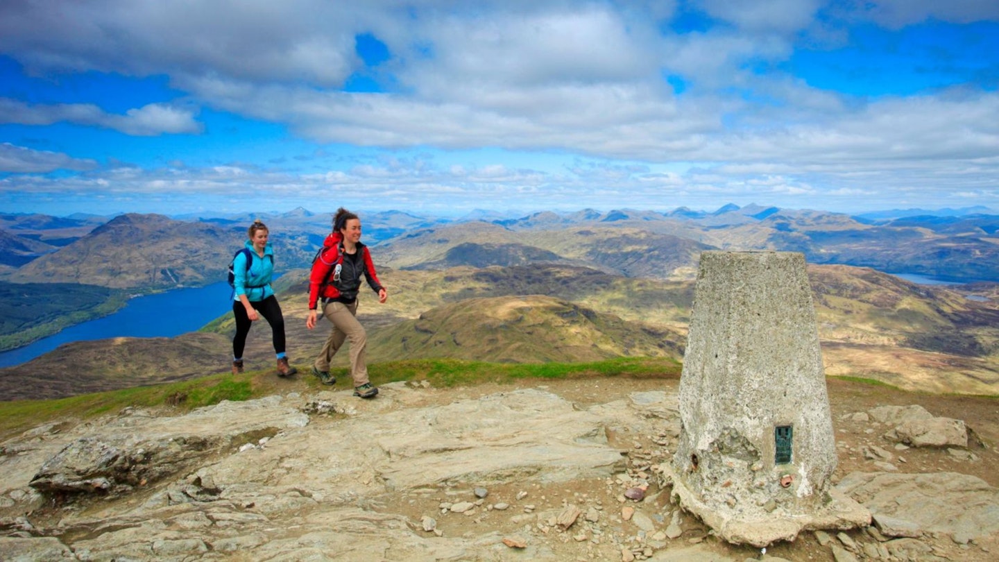 Two walkers approaching Ben Lomond's summit in the Scottish Highlands