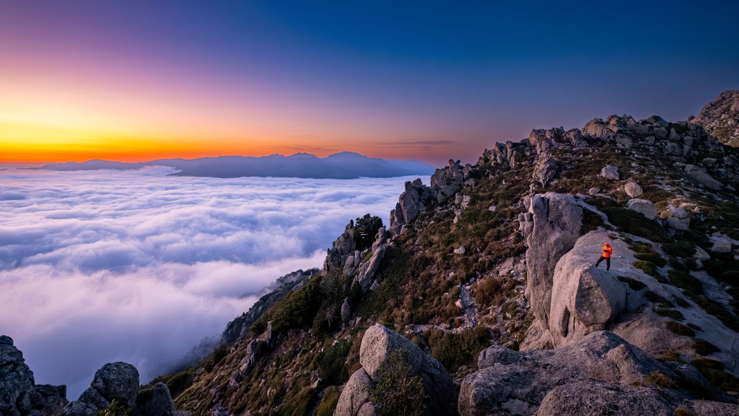 Corsica GR20 Day 10 hiker at sunset above cloud inversion