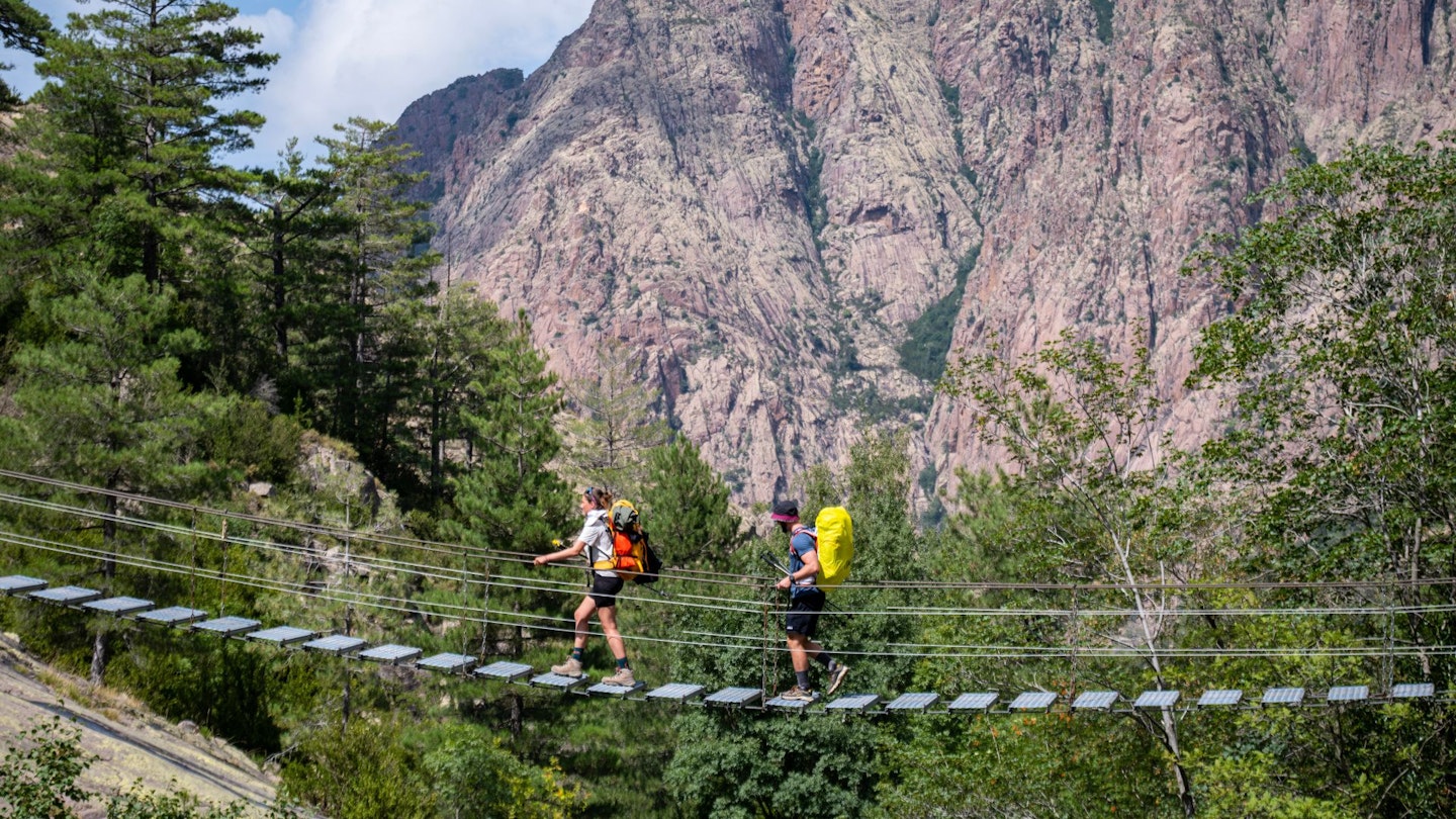Corsica GR20 Day 2 hikers crossing a rope bridge
