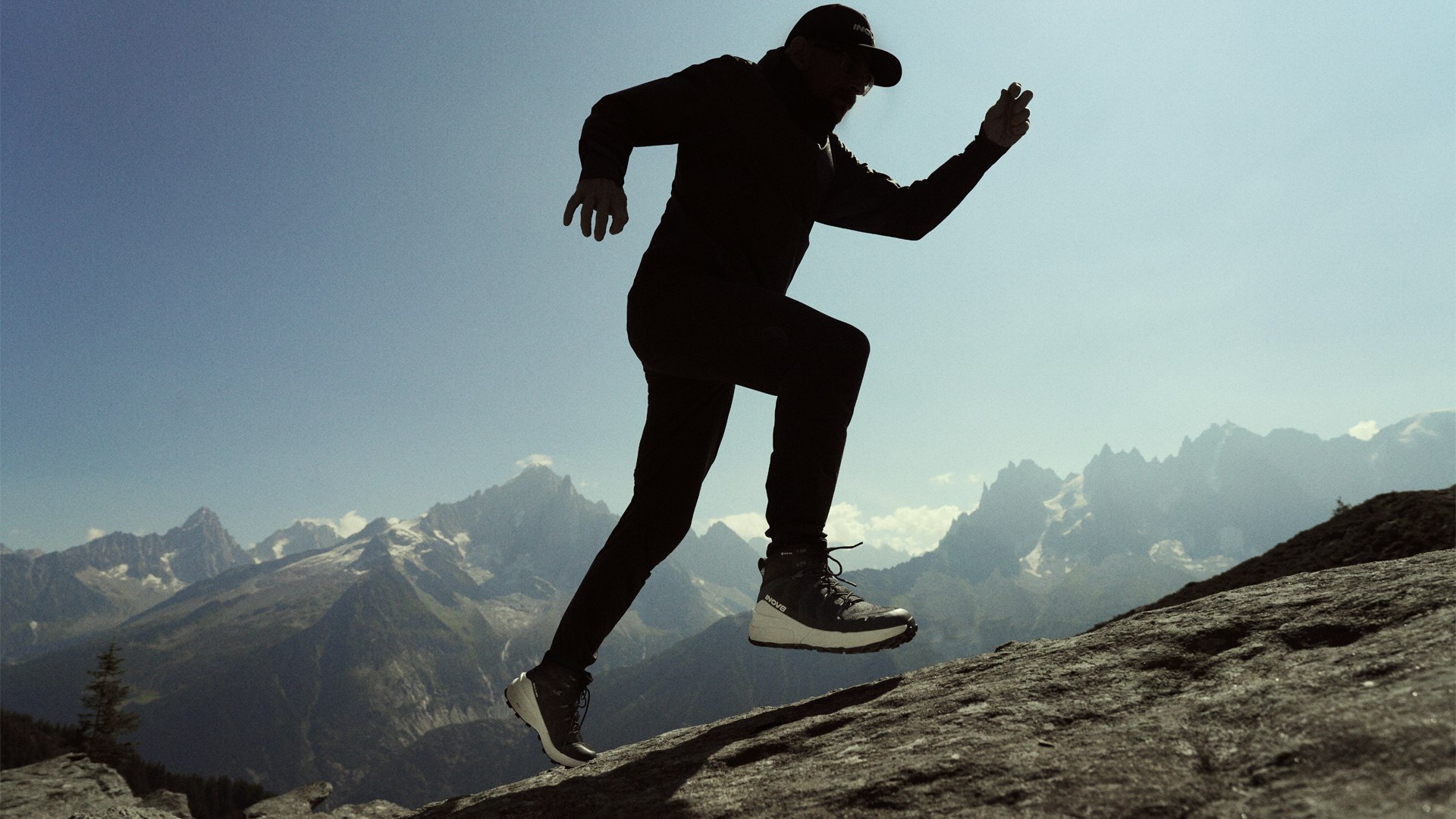 Hiker on a mountain wearing the inov8 roclite pro walking boot