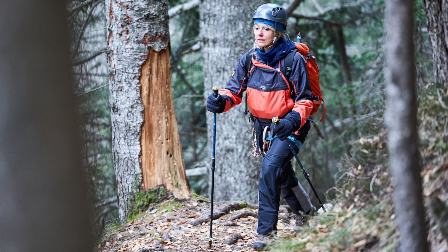 Female Hikker in forest wearing Paramo Analogy waterproof smock