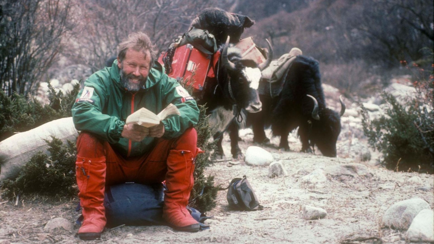 Sir Chris Bonington reading with yaks near Menlungtse in 1987