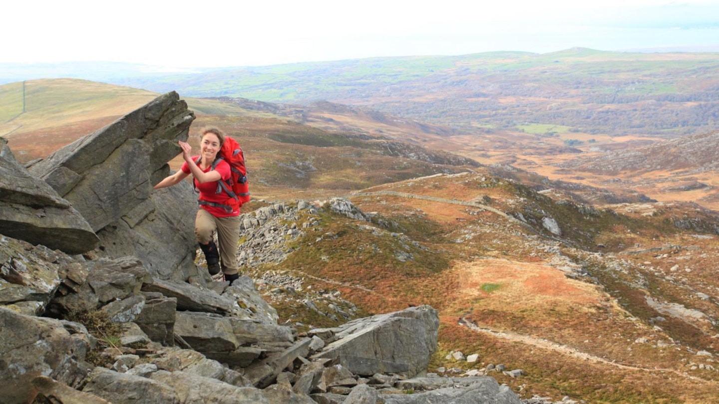 Female hiker high on western edge of Rhinog Fawr Snowdonia