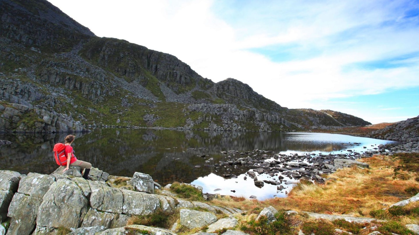 Hiker looking over Llyn Du Rhinog Fawr Snowdonia