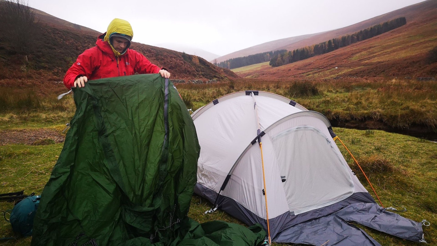 Putting a tent up in the rain