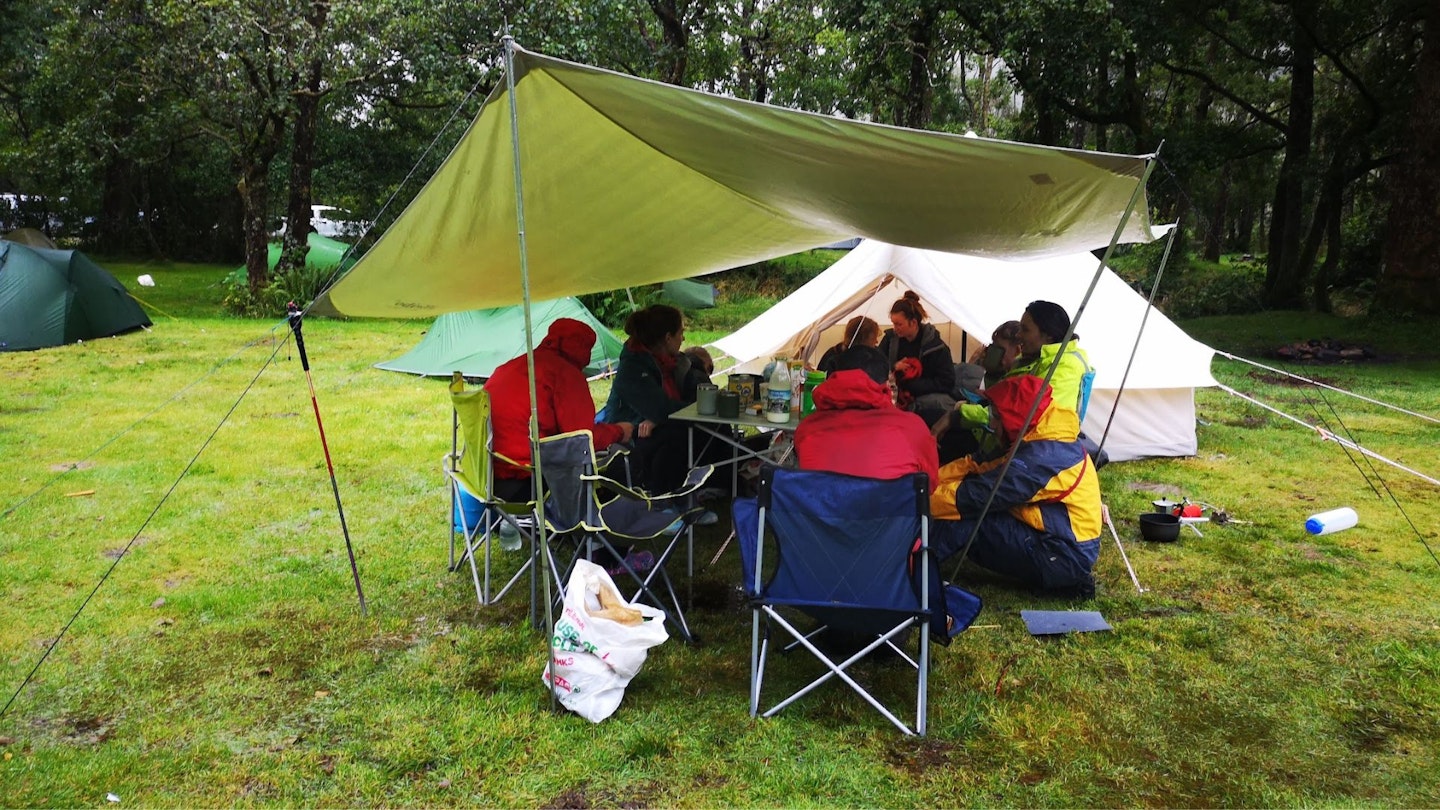 Putting tarps up to hide from the rain