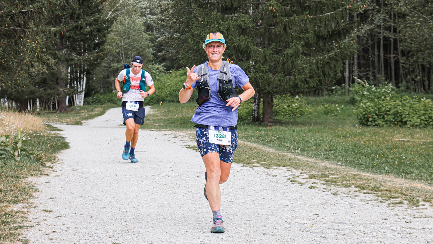 female runner overtaking male trail runner in the woodland