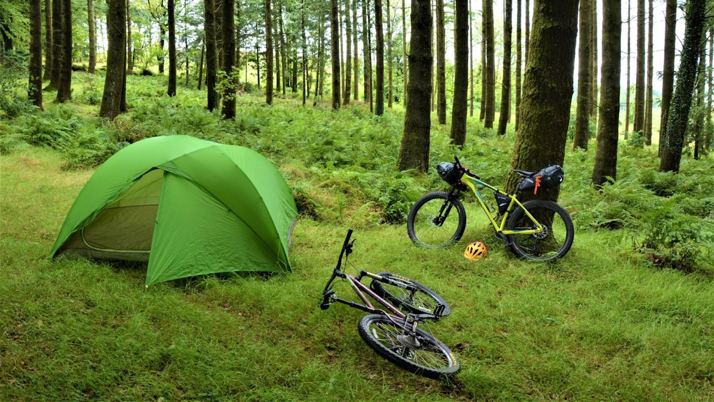 Bikepacking camp setup with bikes and tent