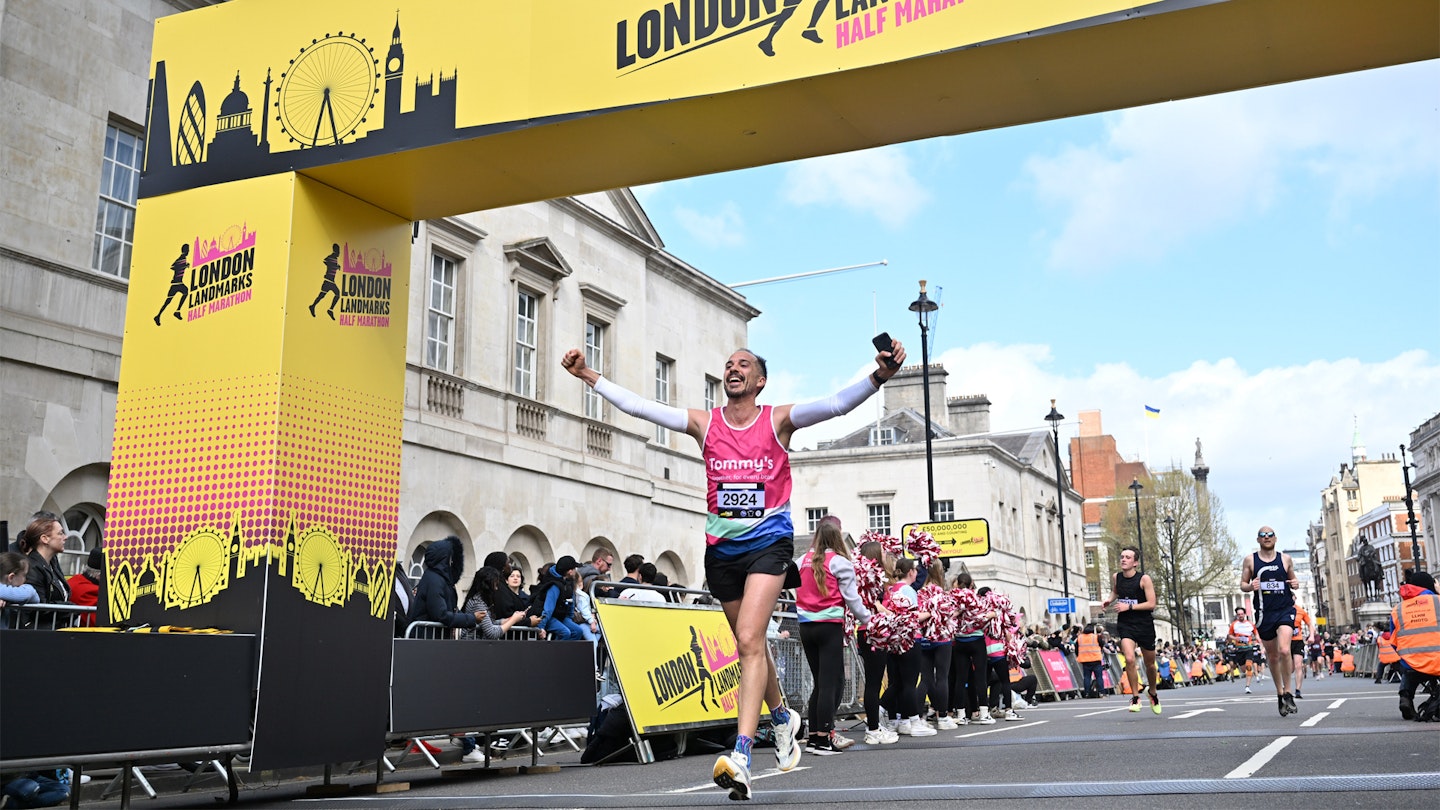 Runner crossing the london landmarks half marathon finish line