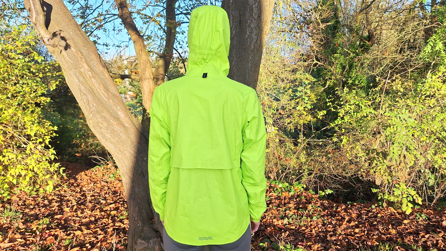 back side of the Janji Rainrunner waterproof jacket