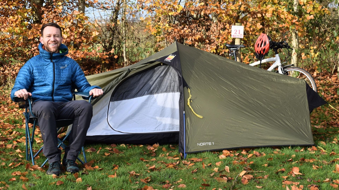 James Forrest next to bikepacking tent