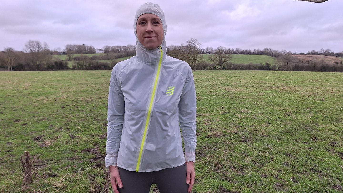 showing off the hood on the compressport hurricane waterproof running jacket