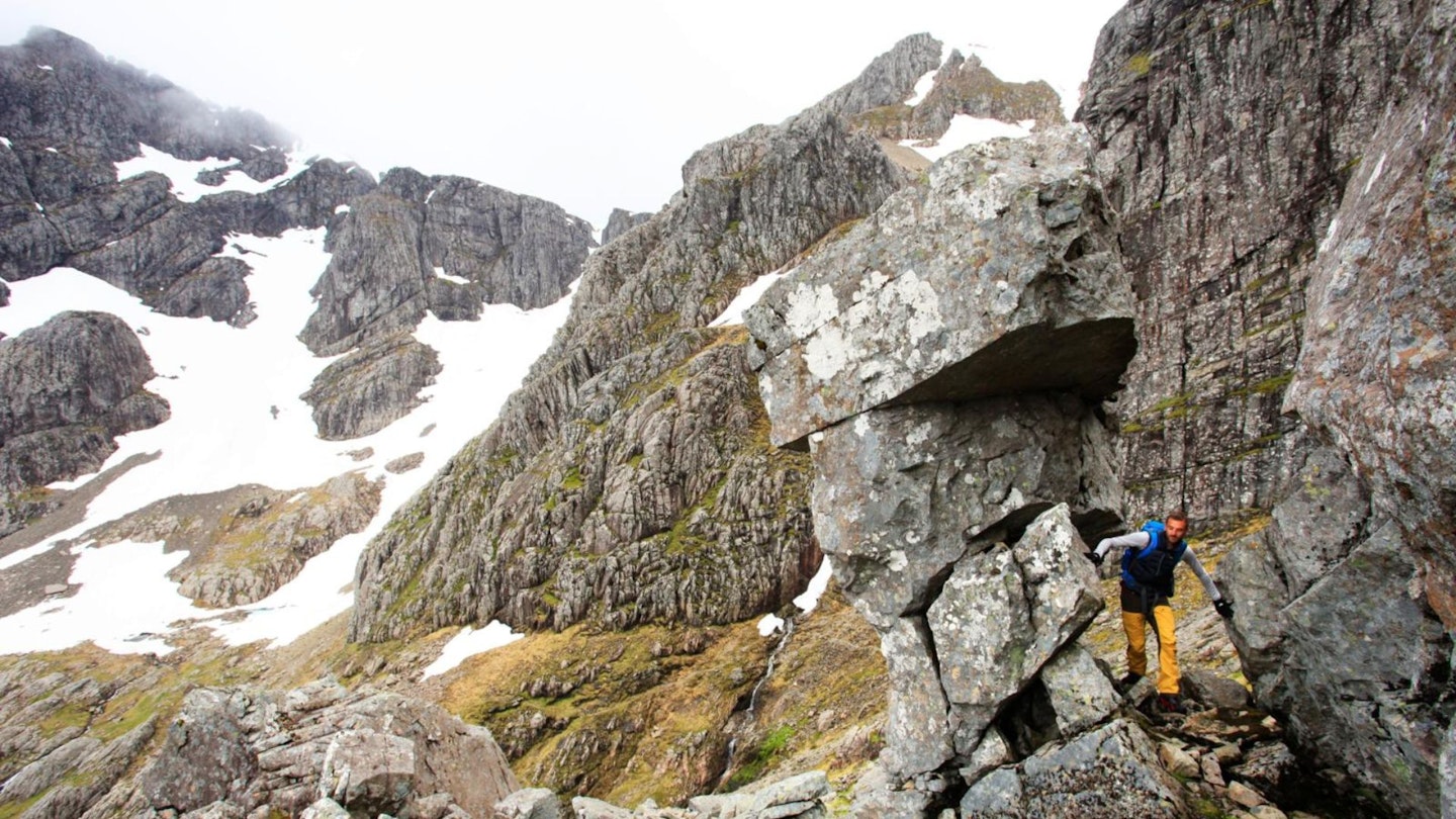 Hiker buy a rock tower on Ben Nevis Ledge Route