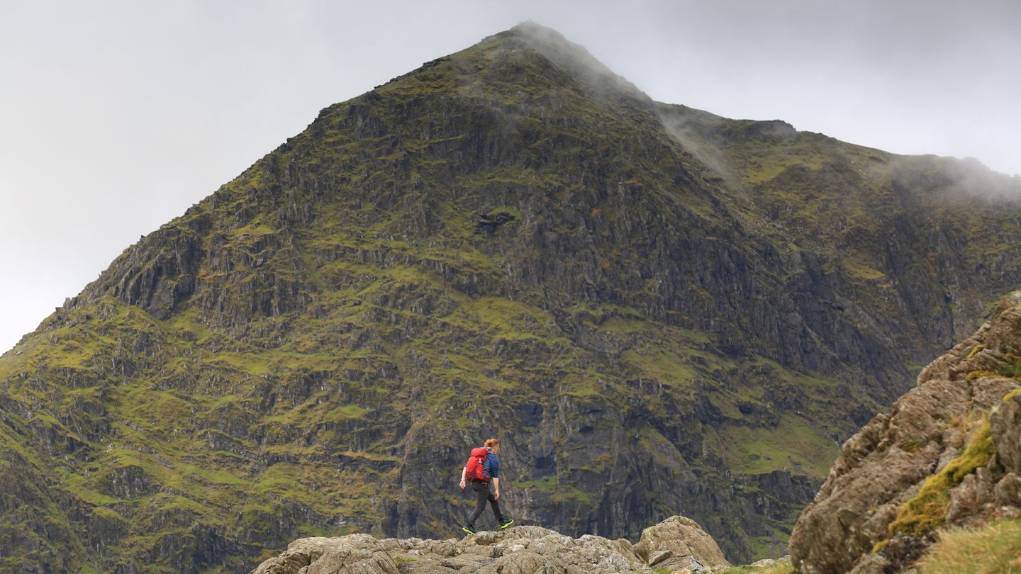 Hiker in front of Snowdon Trinity Face