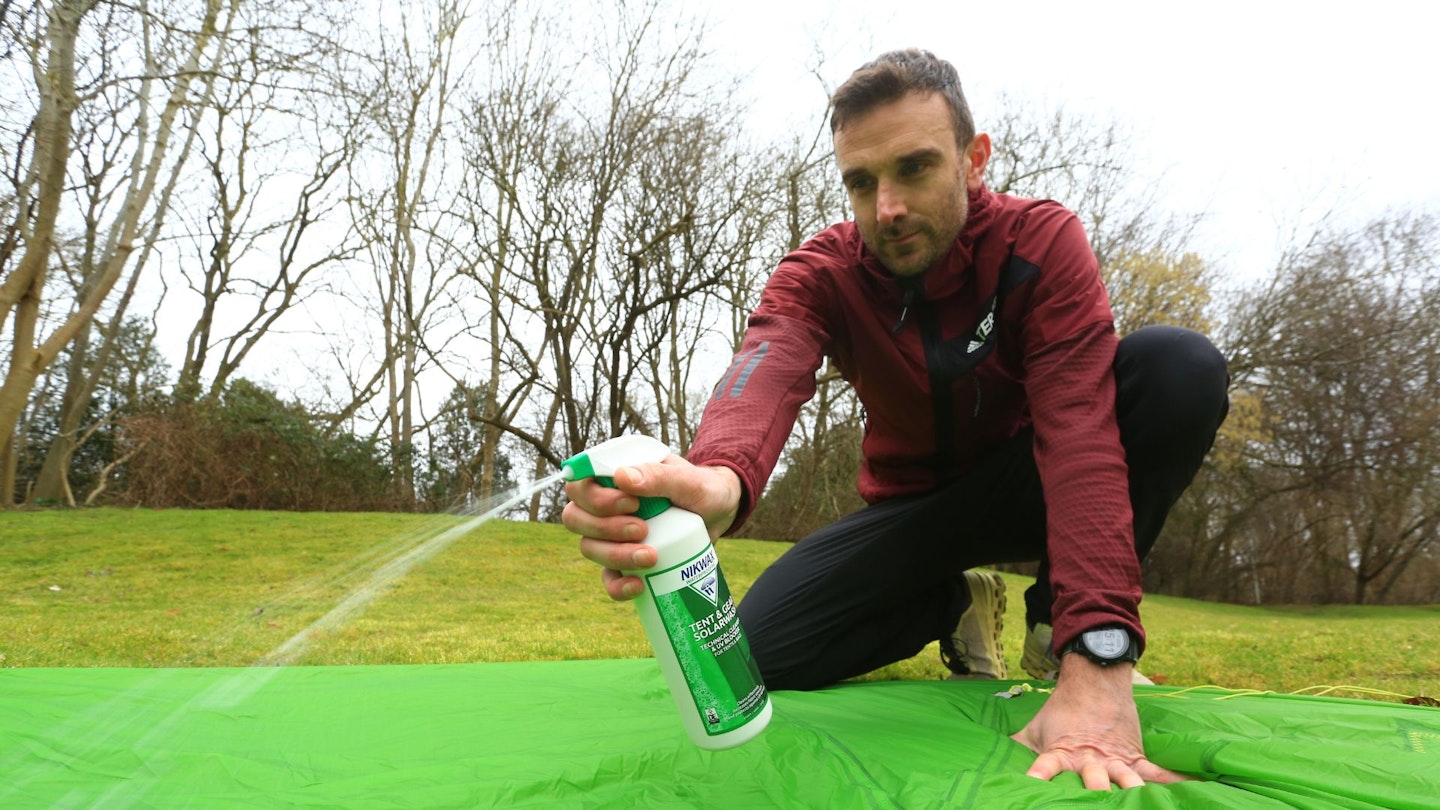 Spraying Nikwax on a tent