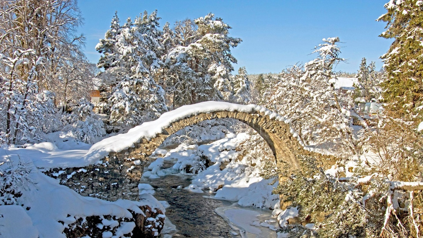 A snow-covered old bridge