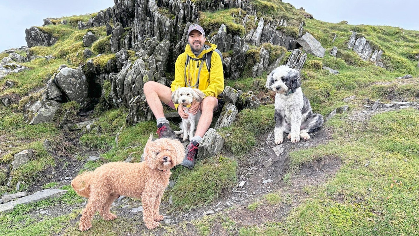 Howard Johnson with his dogs sitting on a rock