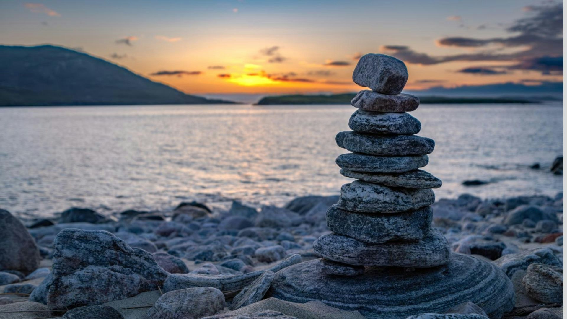 Isle of Harris balanced rock cairn on Traigh Mheilein beach at sunset