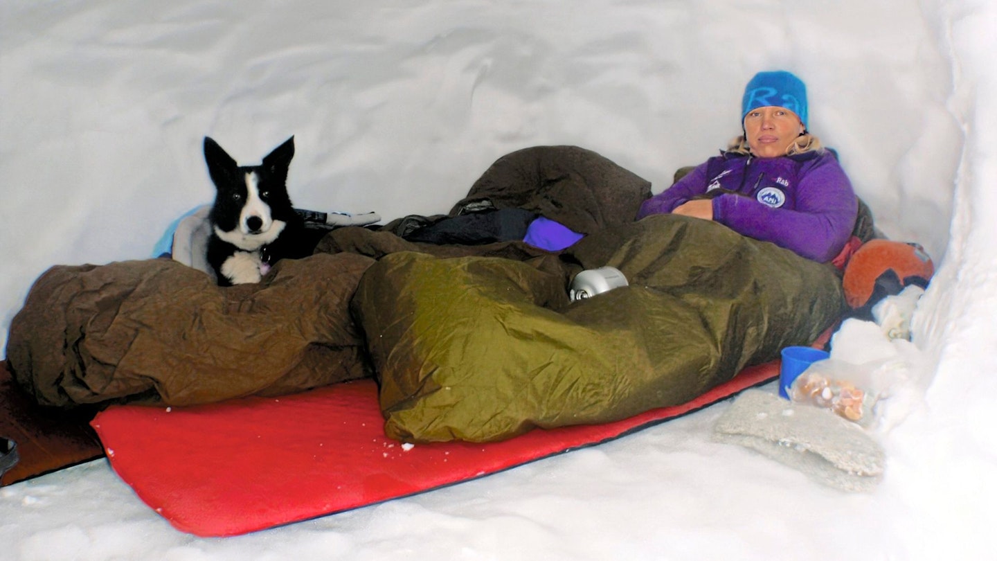 A woman in a snowhole in the Cairngorms