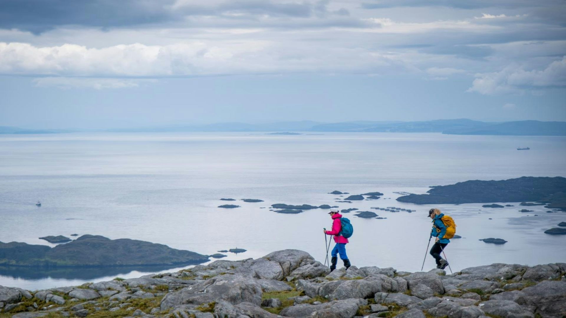 Two hikers on Isle of Harris on Beinn na Teanga on the Glen Skeaudale Horseshoe