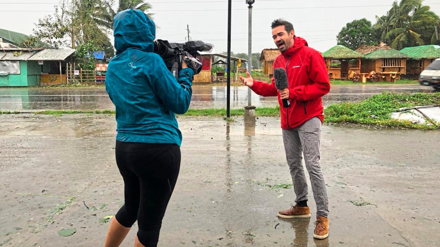 Johnson talking to the camera during a typhoon in the Phillipines.