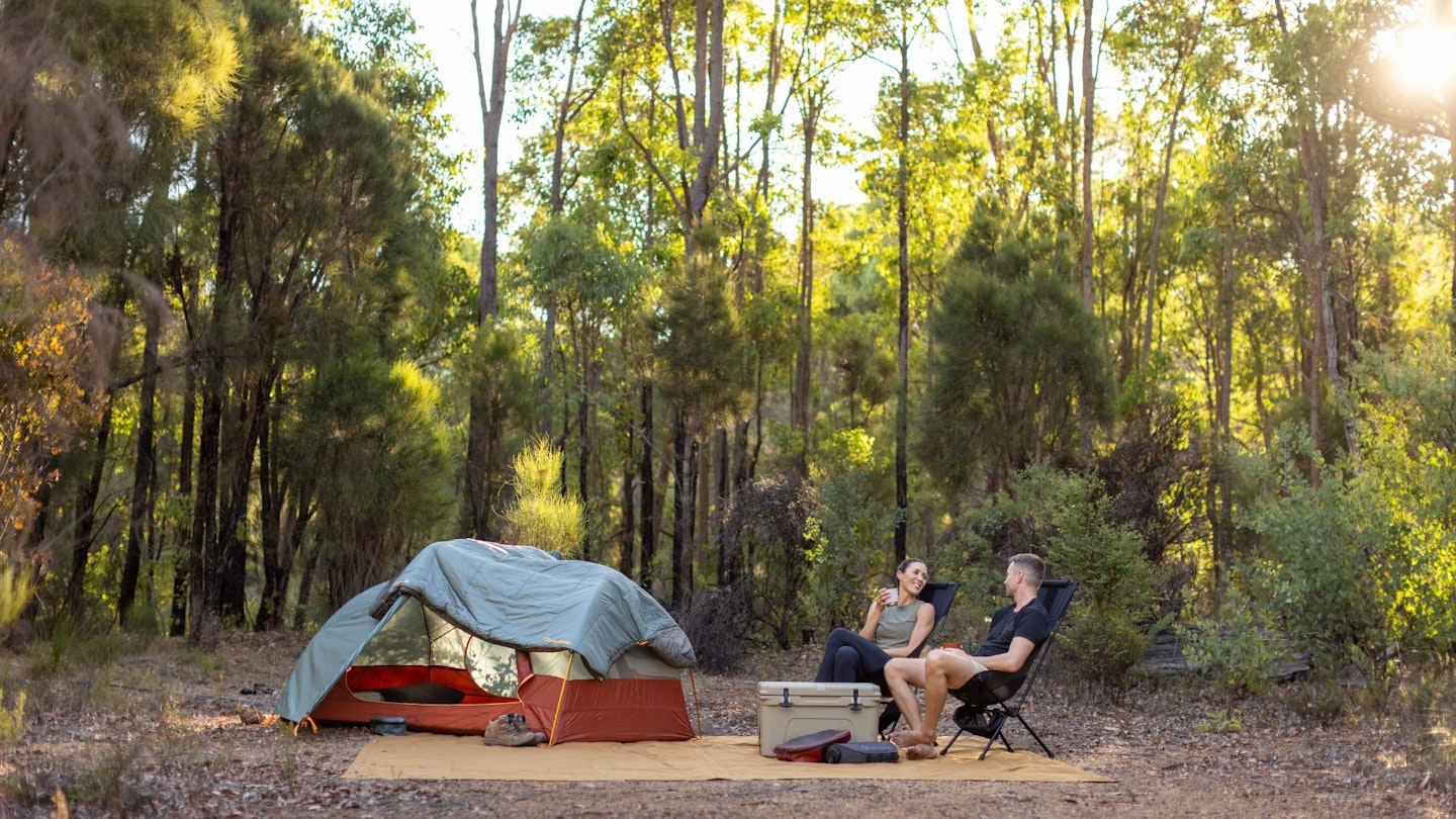 Man and woman in front of a tent