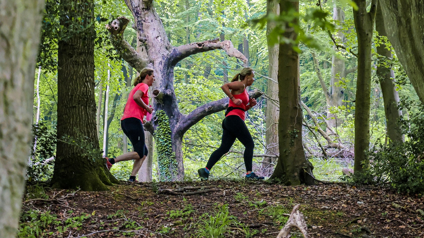 two runners going over a hillock