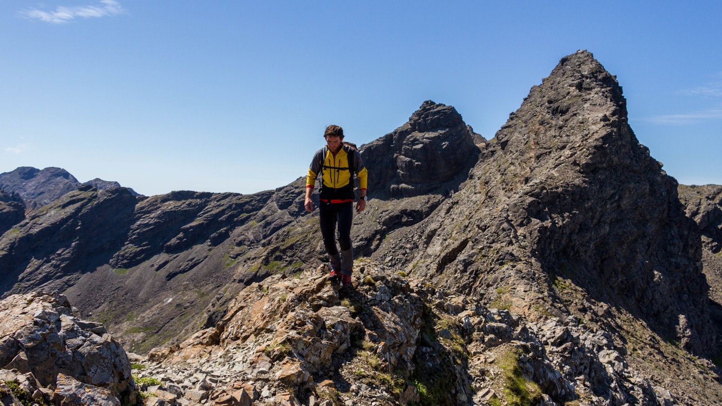 Hiking on Cuillin Ridge with Am Basteir behind, Skye