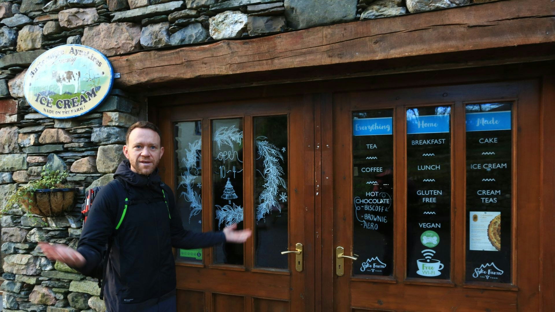 A closed shop in Buttermere, James gestures outside it