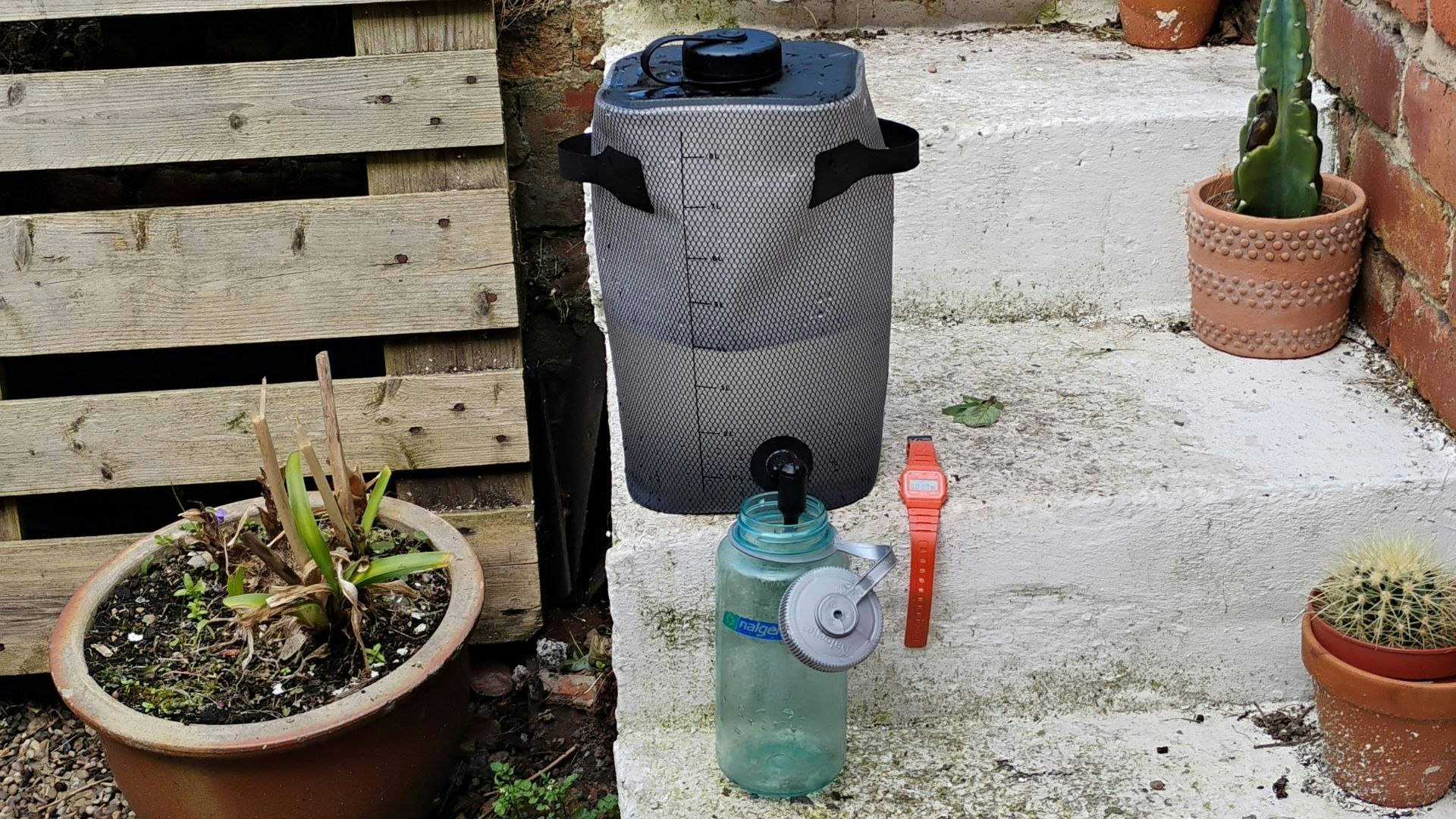 Alpkit Kamel on a step, with a Nalgene below and stopwatch on the right