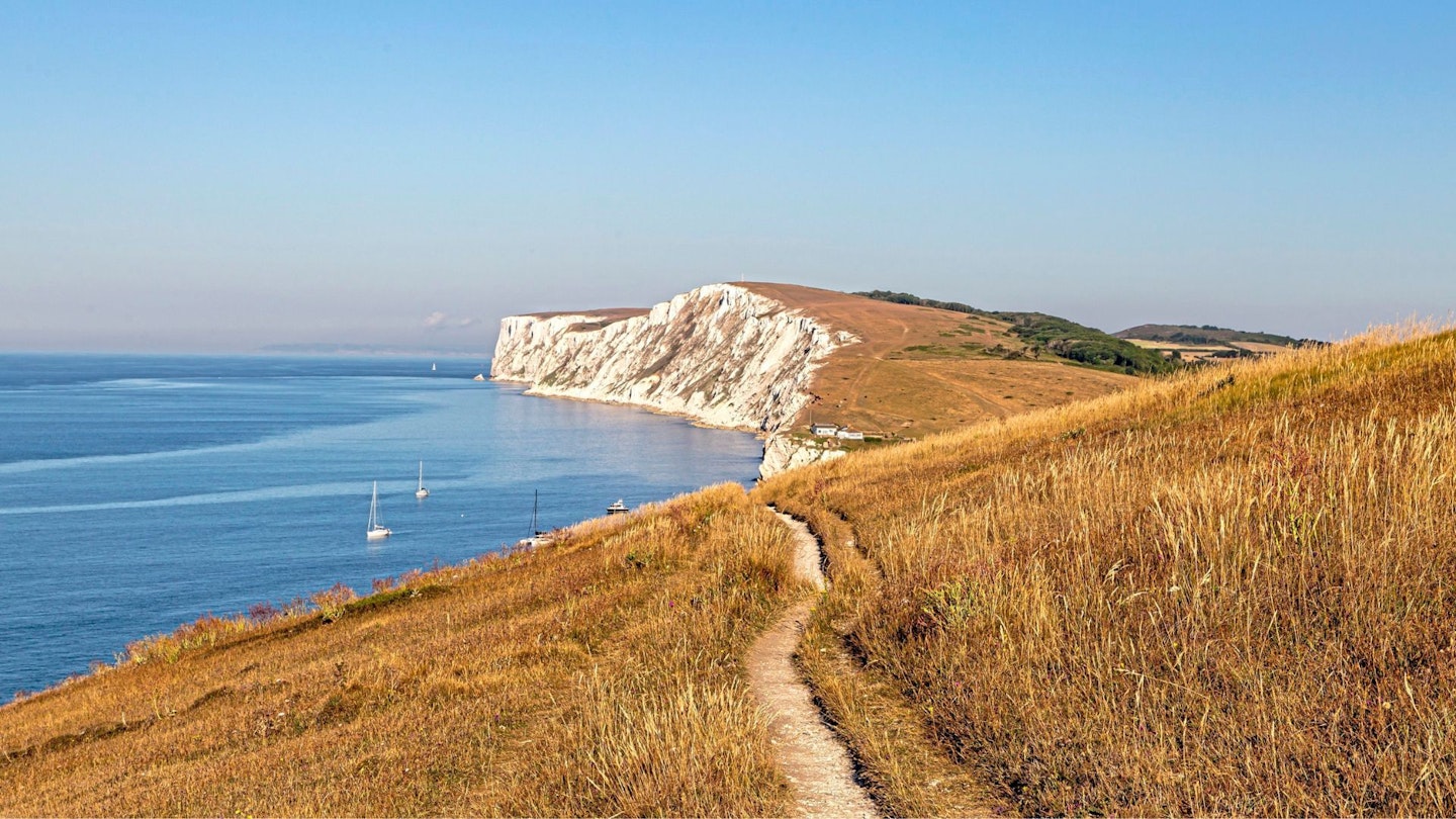 Looking along the coastal path towards the chalk cliffs at Freshwater Bay, on the Isle of Wight