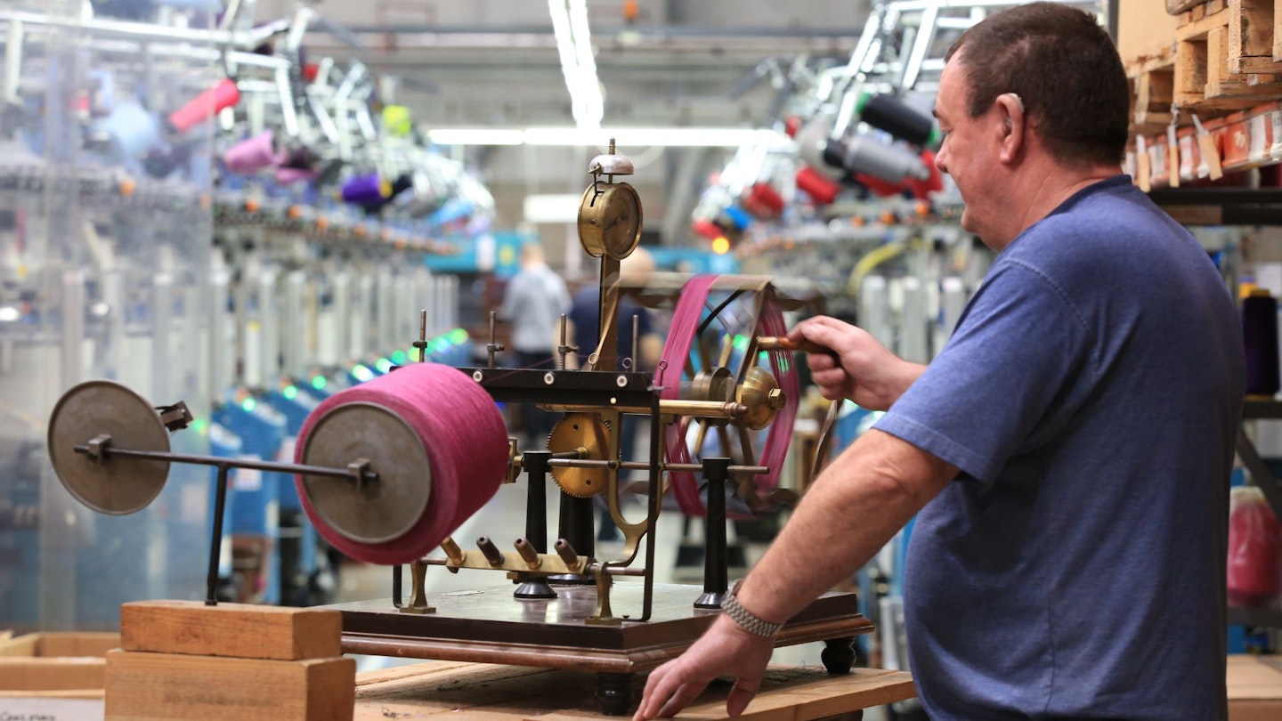 Man uses a yarn winding machine in the Bridgedale Socks factory