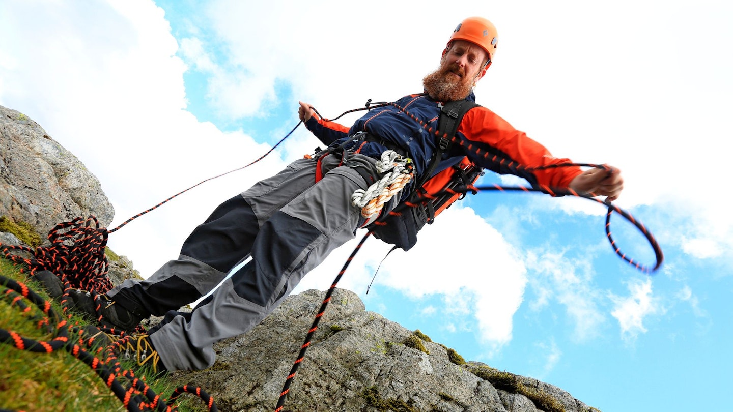 Ben with rope, harness and helmet, preparing to abseil down