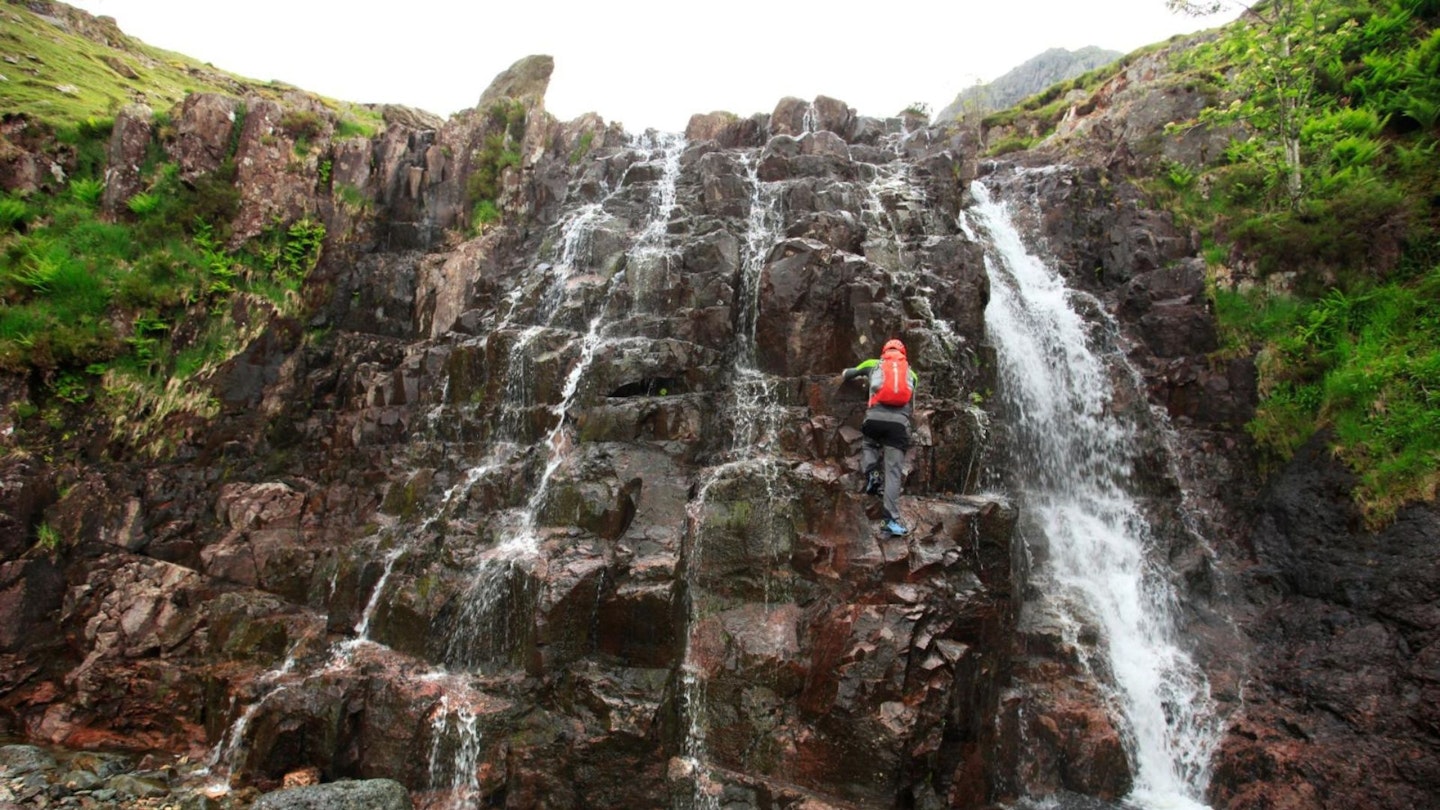 Climbing a waterfall Stickle Ghyll Scramble Langdale Lake District