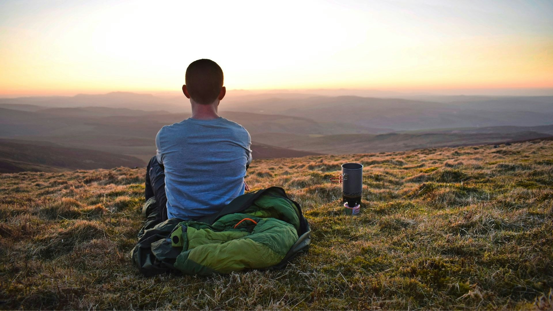 Hiker bivvying on a hilltop