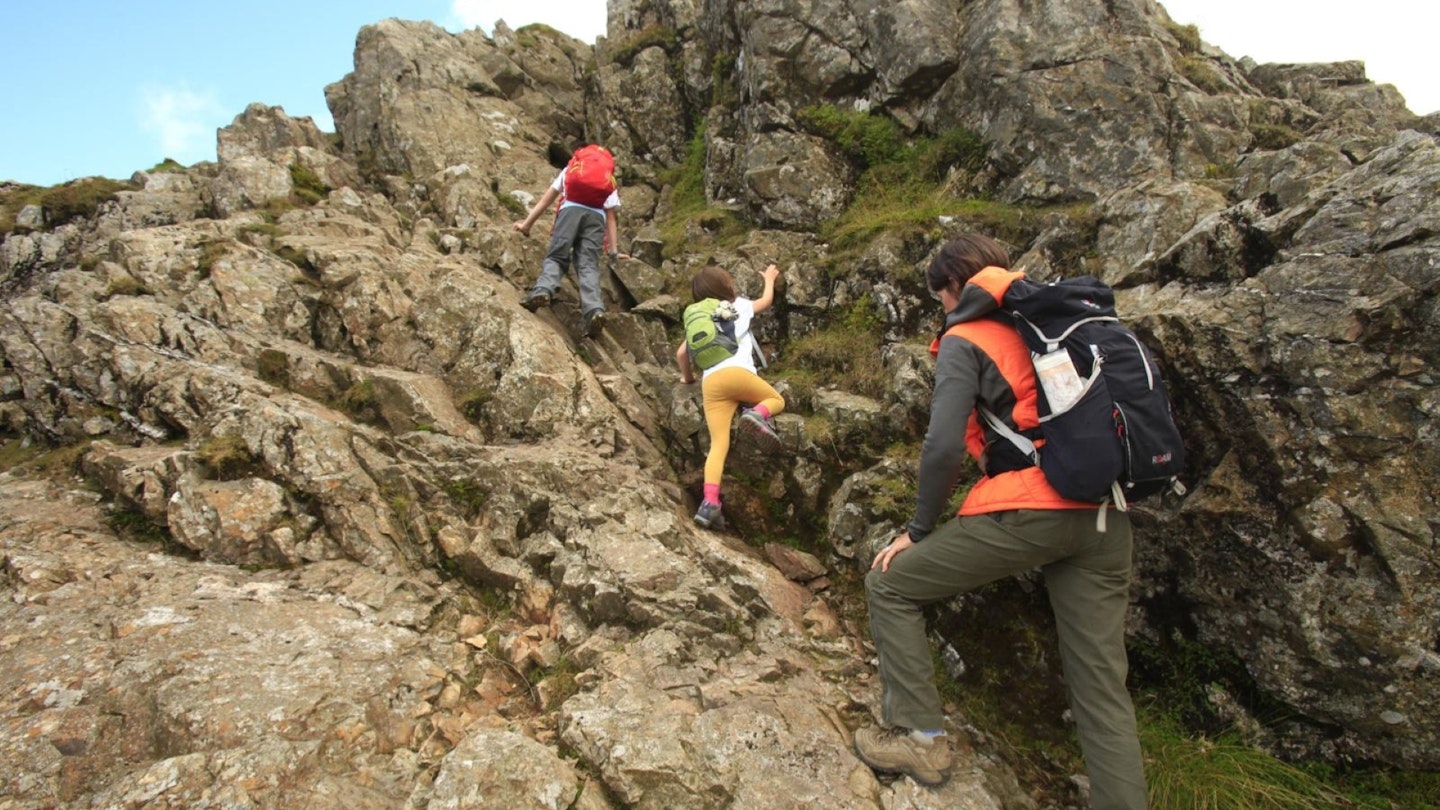 Family with kids Scrambling on Pike of Stickle Lake District