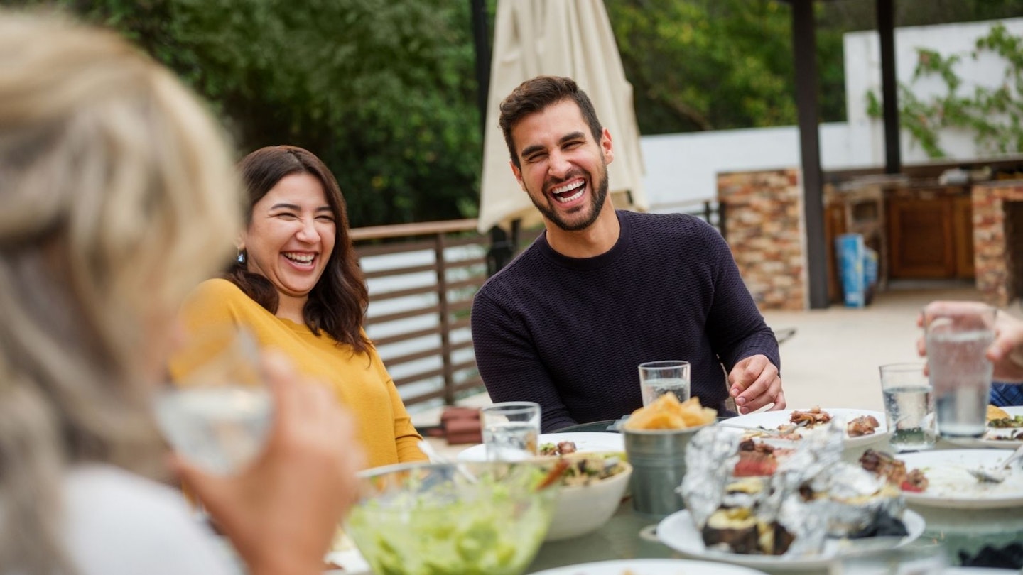 People dining outside from outdoor kitchen