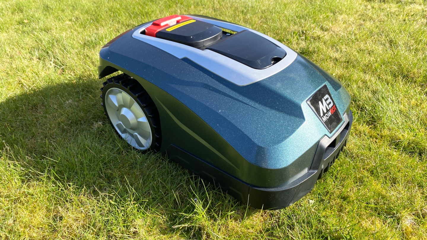 Metallic green Cobra Mowbot sitting on a lawn