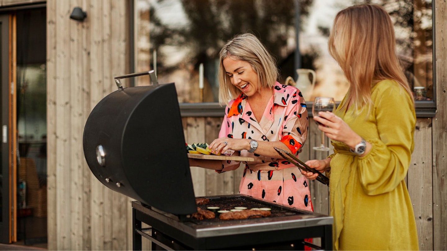 Two women using hybrid bbq