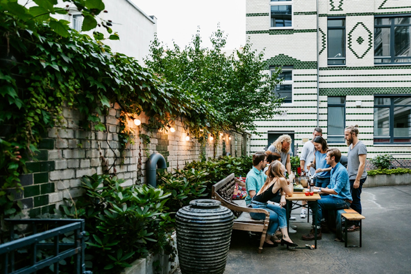 A Group Of Friends Gathered Around Table Preparing For Barbecue