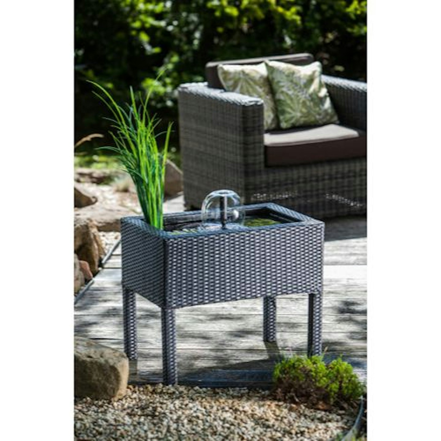 grey rattan raised pond on decking area