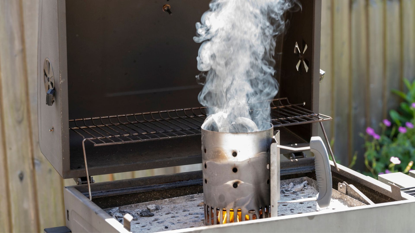 using a chimney to heat charcoal for a BBQ