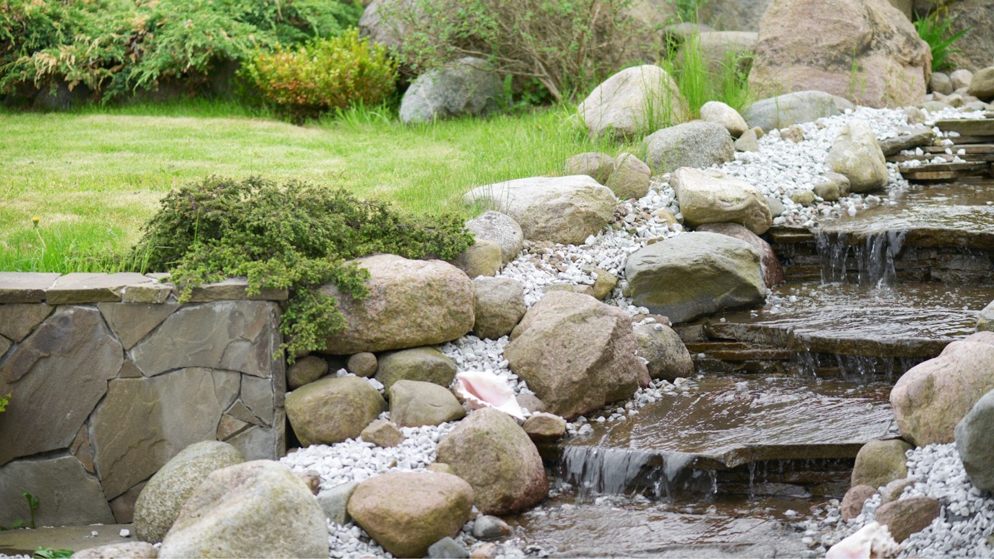 A natural creek made of rocks and flowing water.