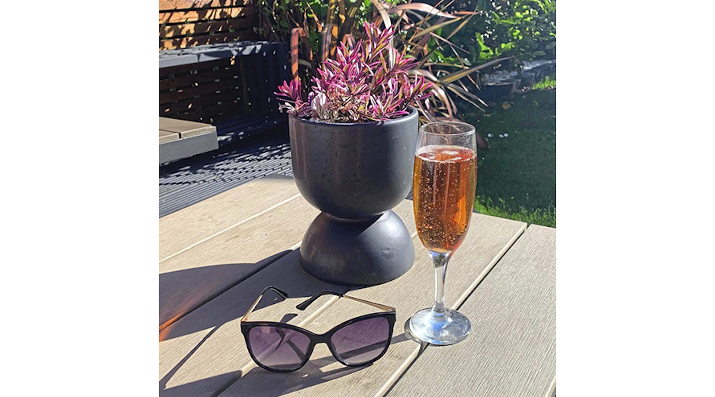 wine and sunglasses on patio table