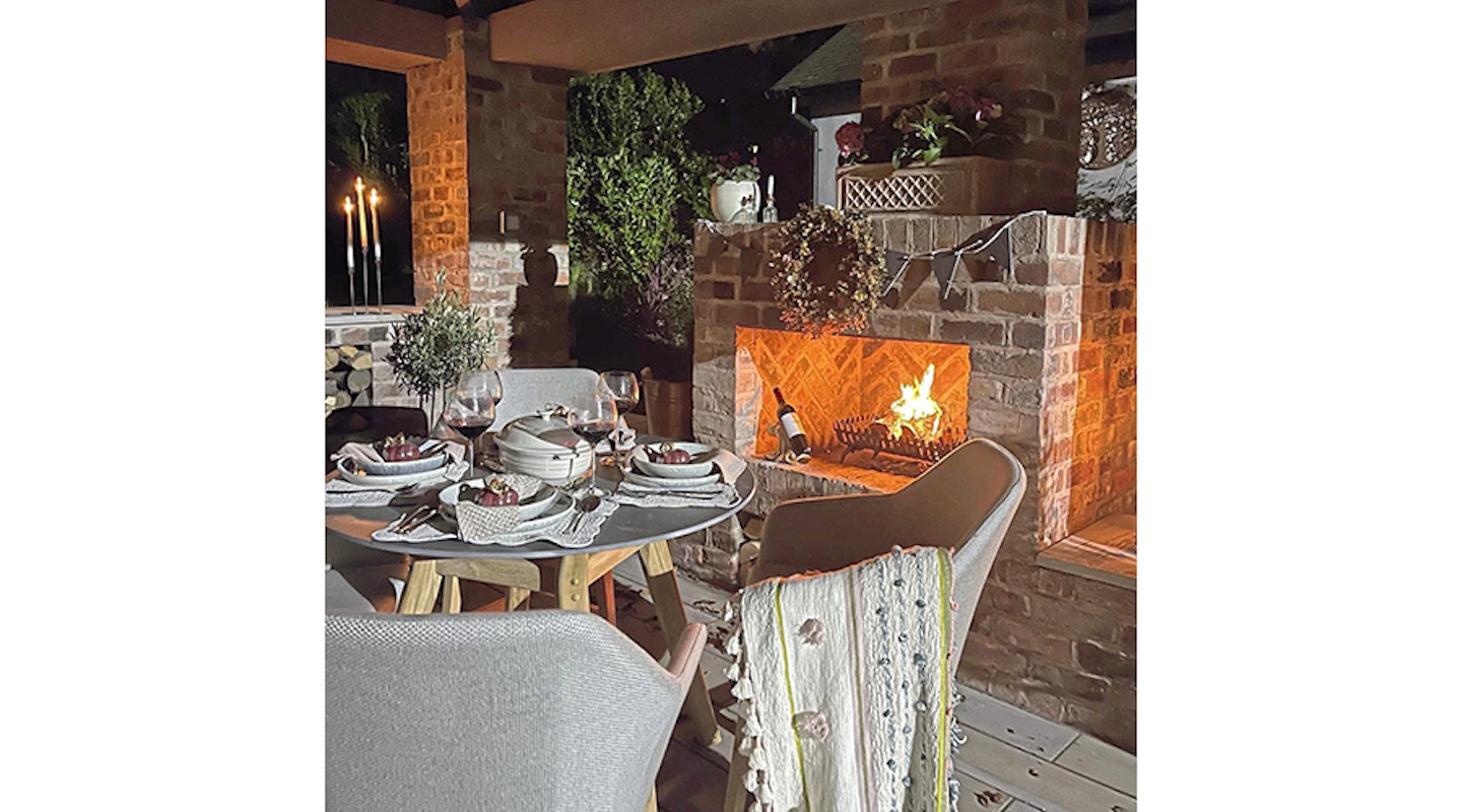 Dining next to outdoor fireplace